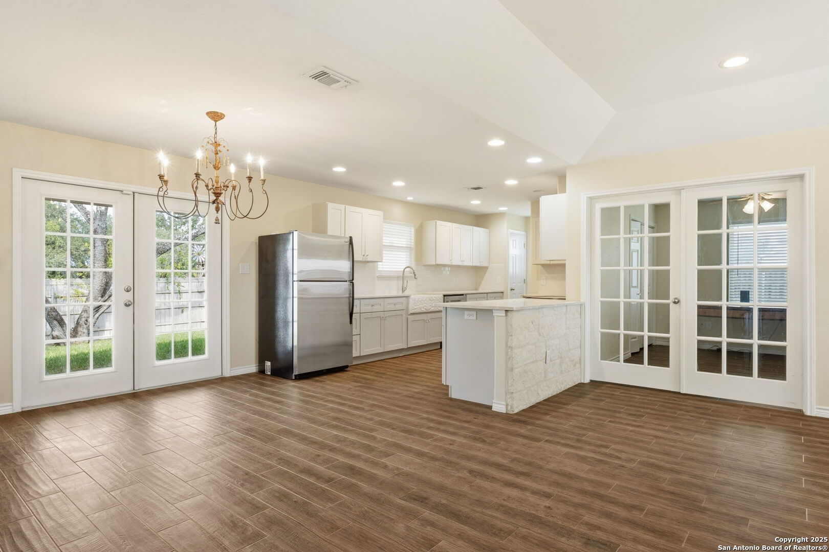 533 Indian Jourdanton, TX 78026 - Photo 21 of 27 a view of a kitchen with refrigerator and wooden floor