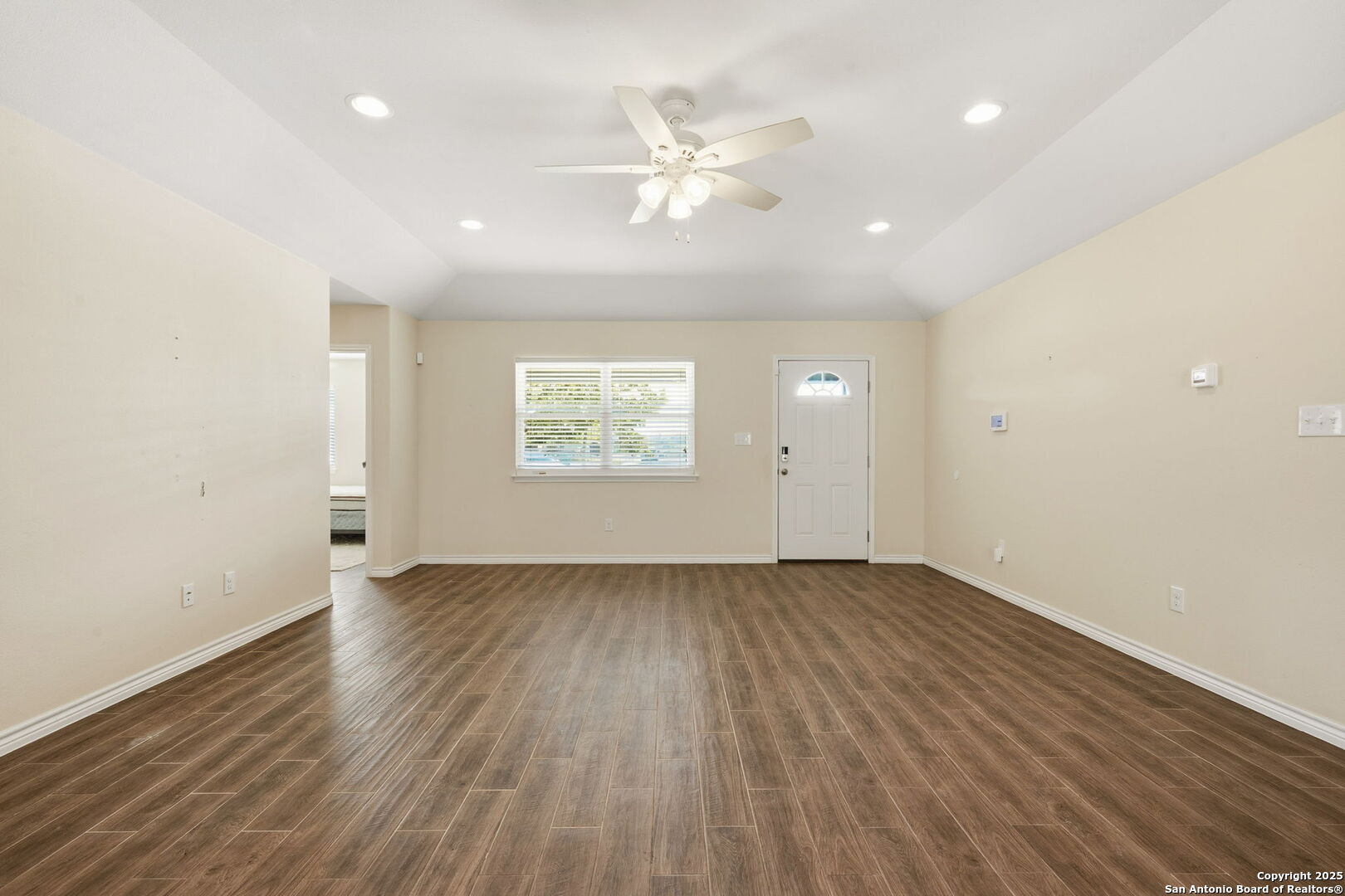 533 Indian Jourdanton, TX 78026 - Photo 4 of 27 an empty room with wooden floor and windows