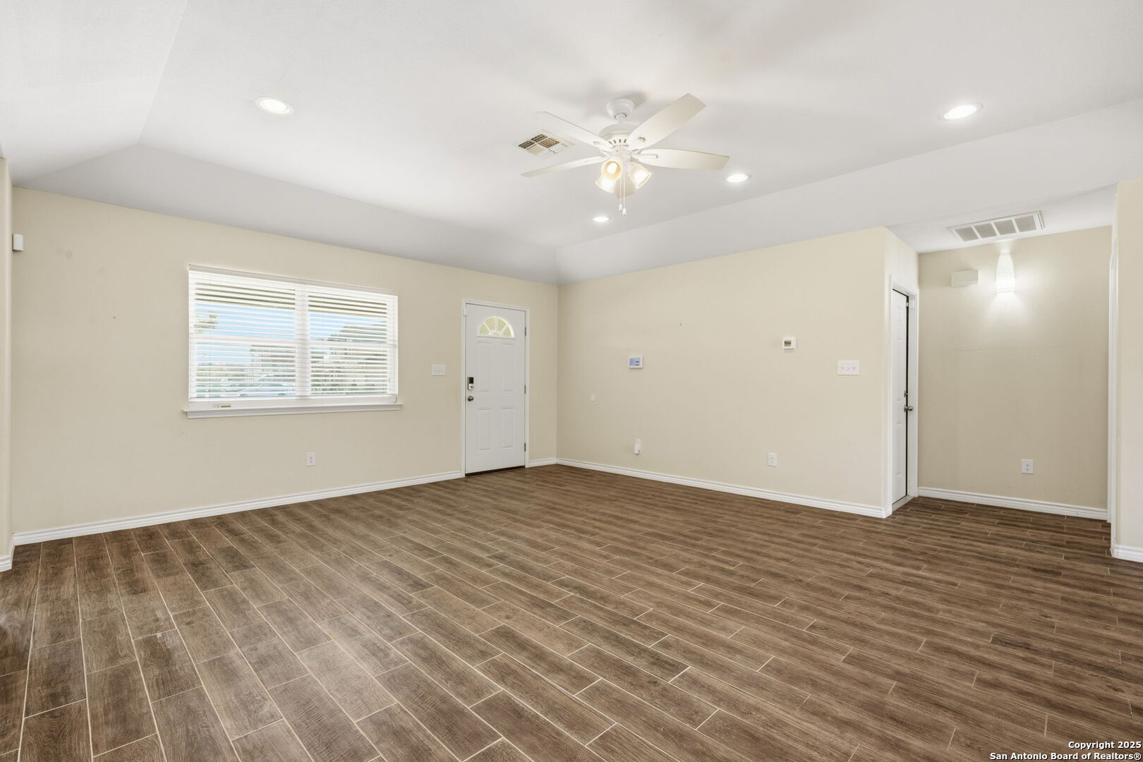 533 Indian Jourdanton, TX 78026 - Photo 5 of 27 wooden floor in an empty room with a window