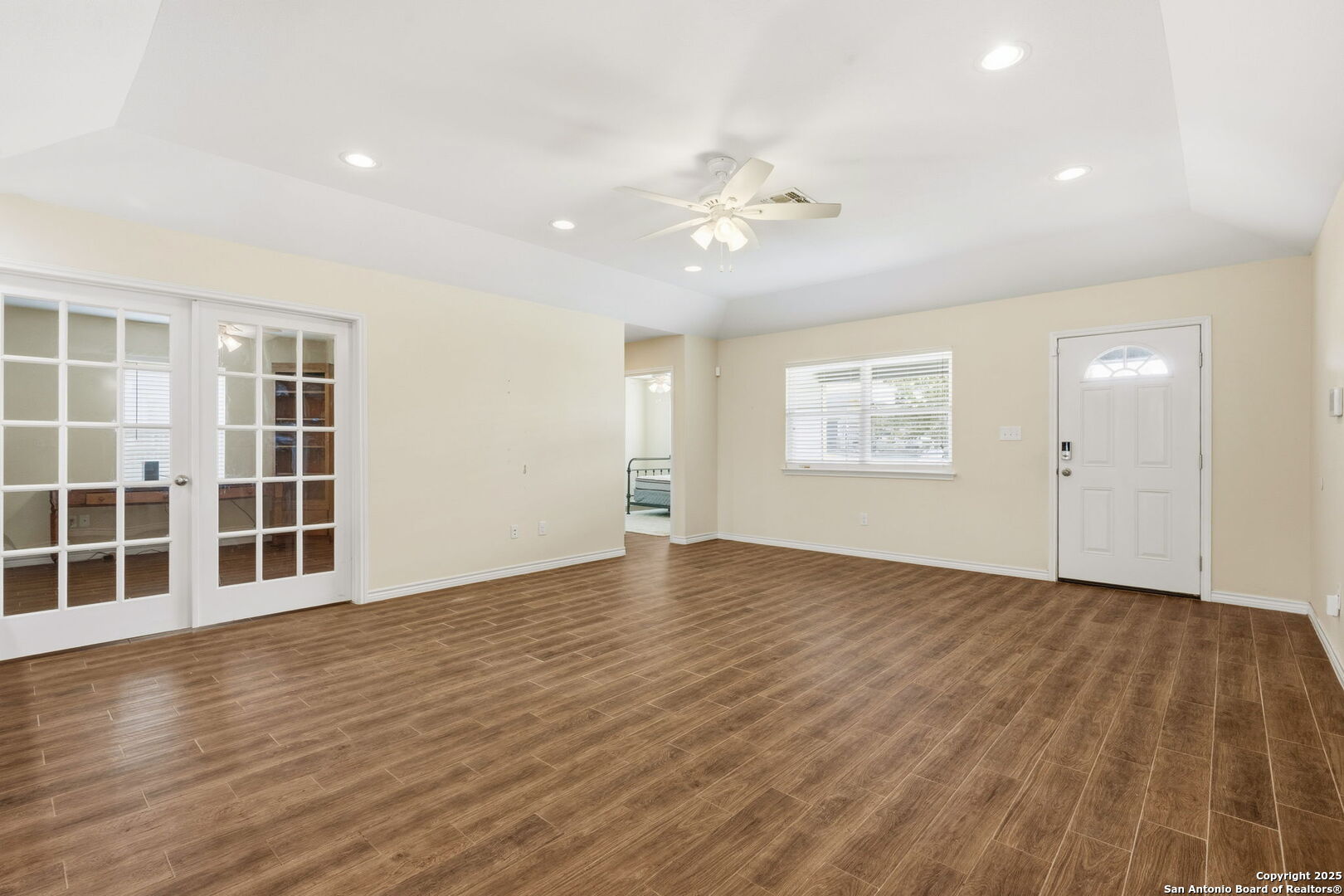 533 Indian Jourdanton, TX 78026 - Photo 6 of 27 an empty room with wooden floor and windows