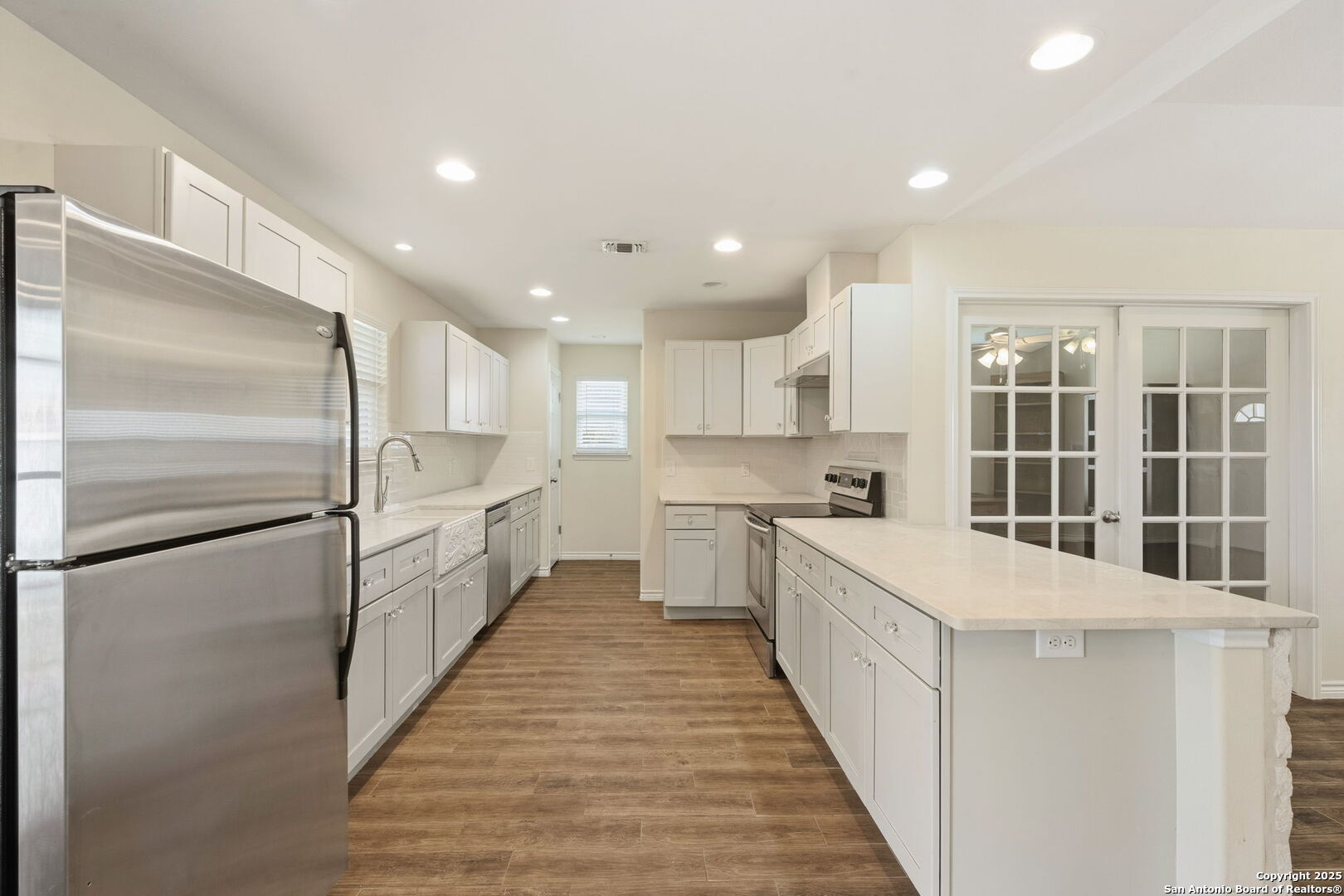 533 Indian Jourdanton, TX 78026 - Photo 8 of 27 a large kitchen with kitchen island a large counter top space a sink stainless steel appliances and cabinets