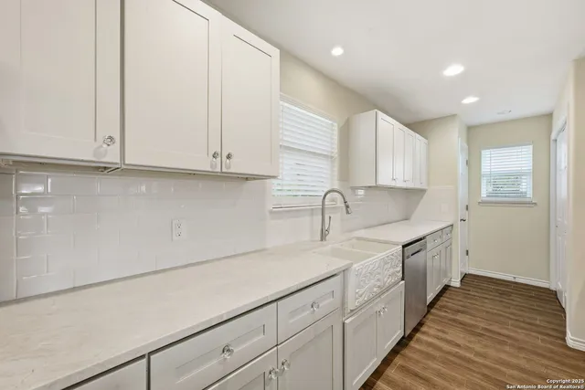 a kitchen with a sink and cabinets