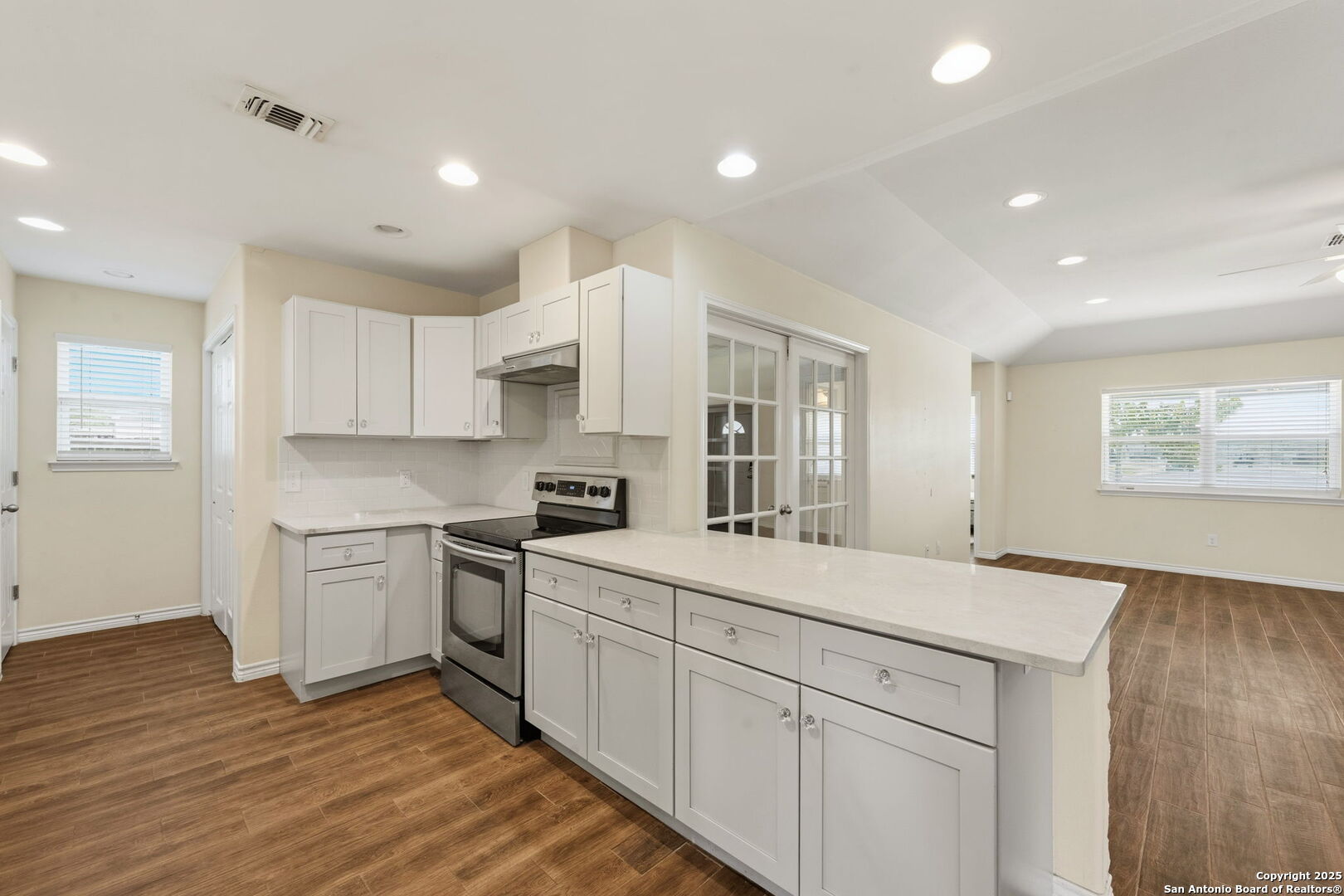 533 Indian Jourdanton, TX 78026 - Photo 10 of 27 a kitchen with white cabinets appliances and wooden floor