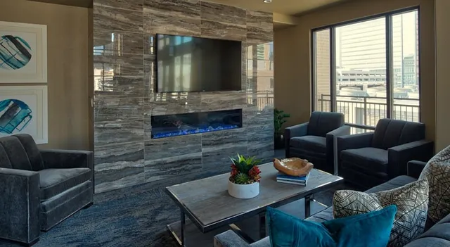 a view of a livingroom with furniture and floor to ceiling window