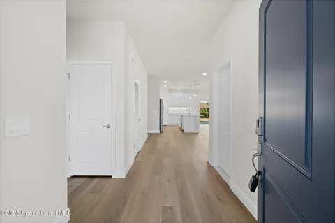 a view of a kitchen with a sink and a refrigerator