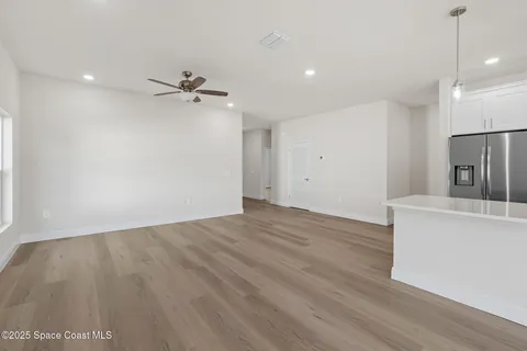a view of a kitchen with kitchen island a counter top space appliances and cabinets