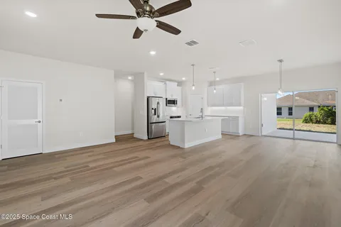 a large white kitchen with a stove a sink and a refrigerator
