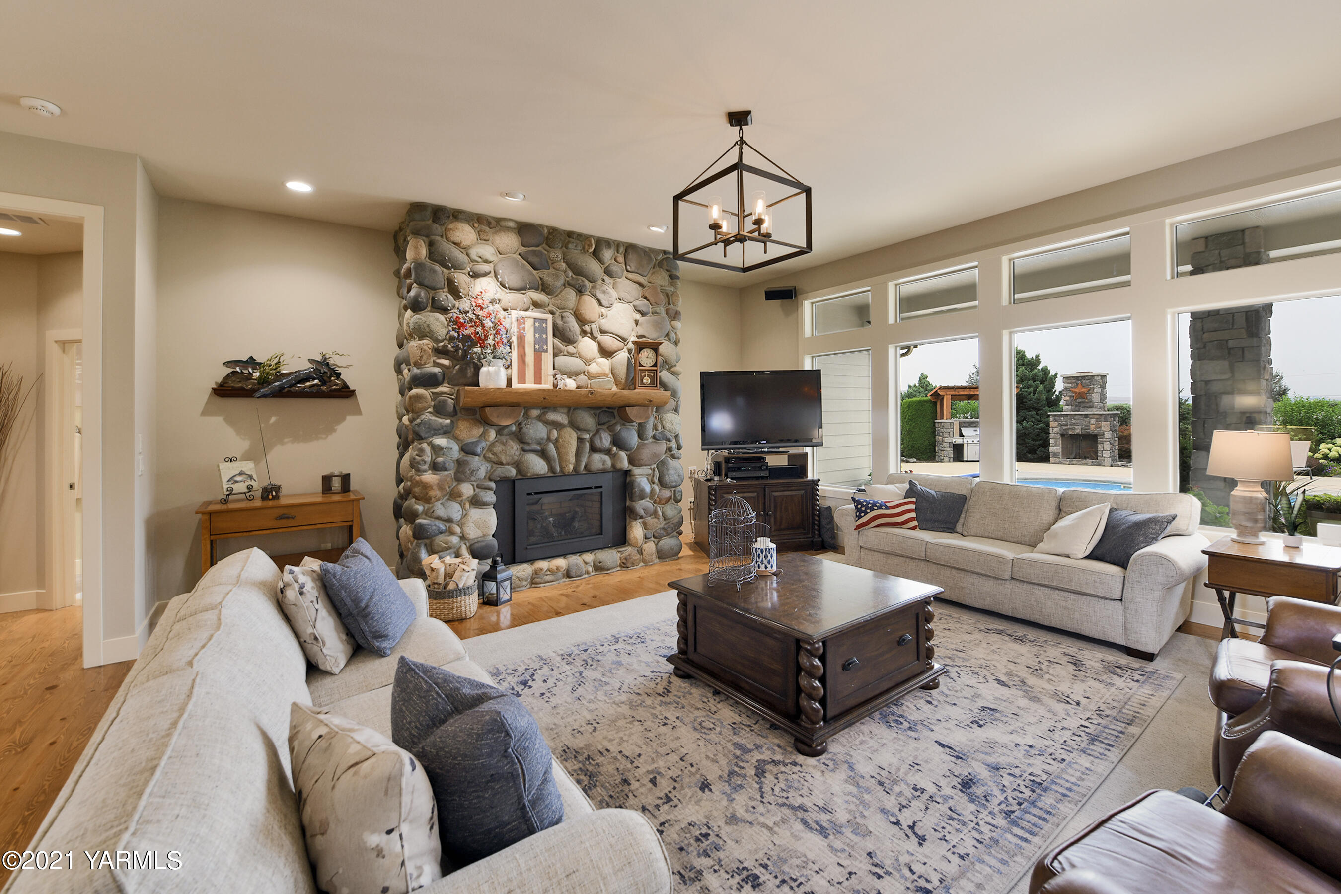 478 Pomona Heights Road Yakima, WA 98901 - Photo 14 of 60 a living room with furniture a fireplace and a chandelier