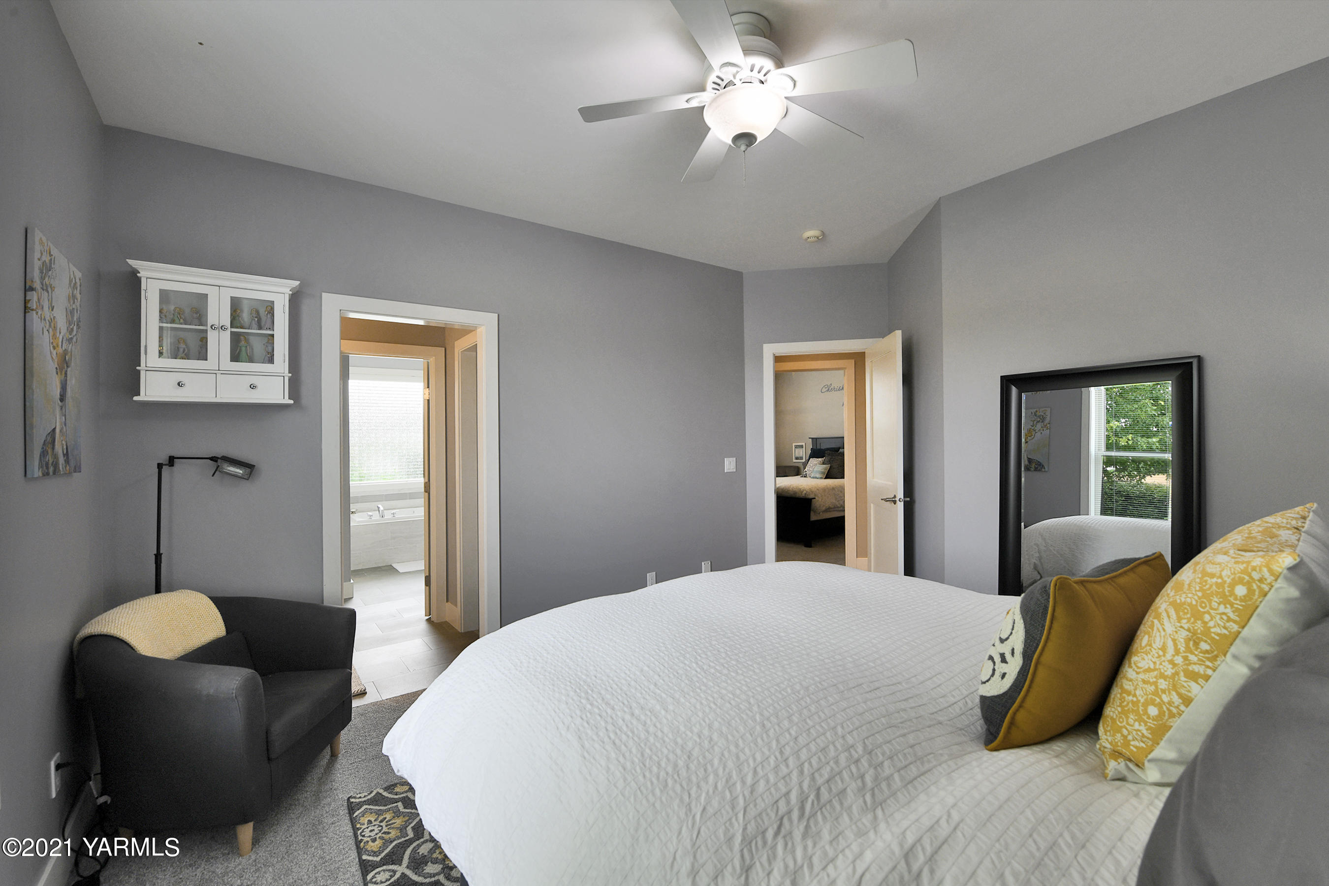 478 Pomona Heights Road Yakima, WA 98901 - Photo 26 of 60 a spacious bedroom with a bed and chandelier