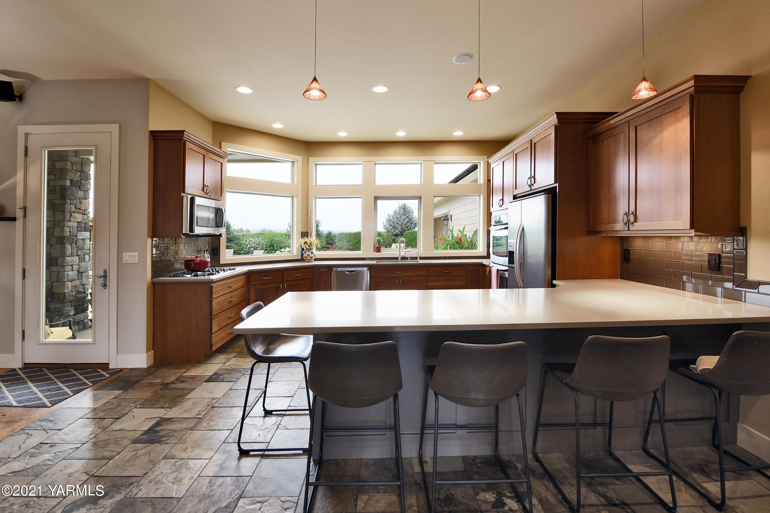 478 Pomona Heights Road Yakima, WA 98901 - Photo 9 of 60 a kitchen with a table chairs sink and cabinets