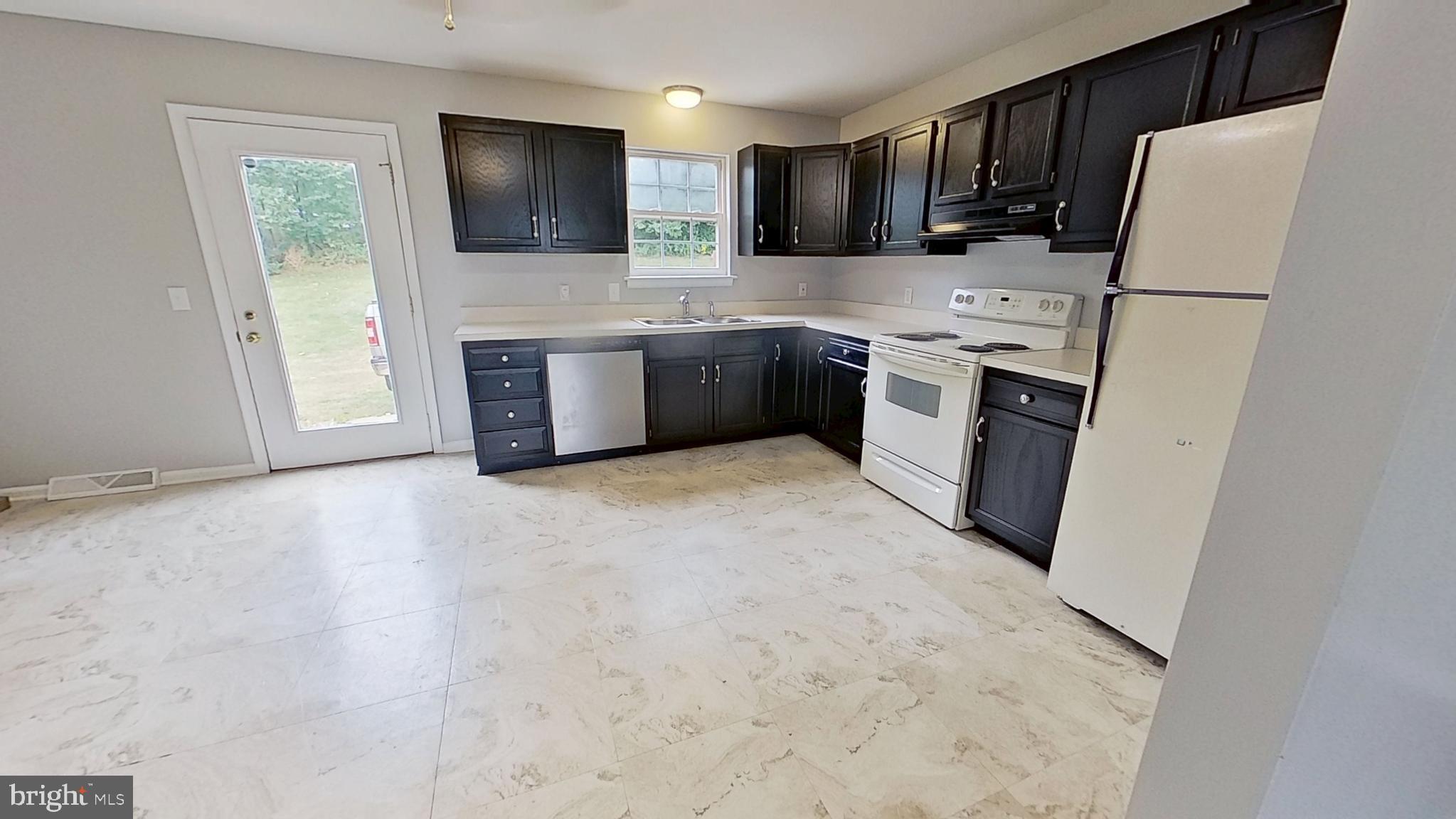 231 Olney Road Dallastown, PA 17313 - Photo 3 of 8 a kitchen with a sink a stove and refrigerator