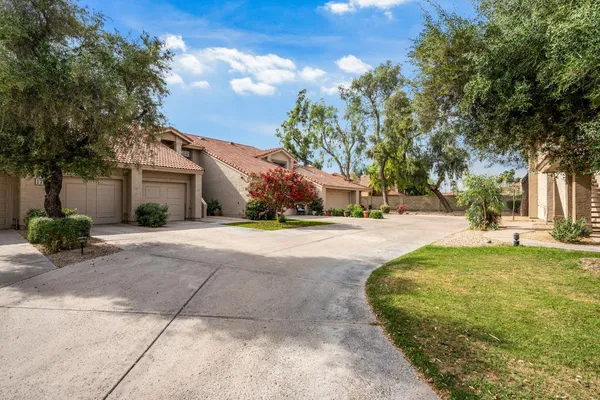 a view of yard with swimming pool and green space