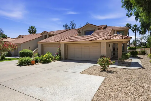 a front view of a house with a yard and a garage