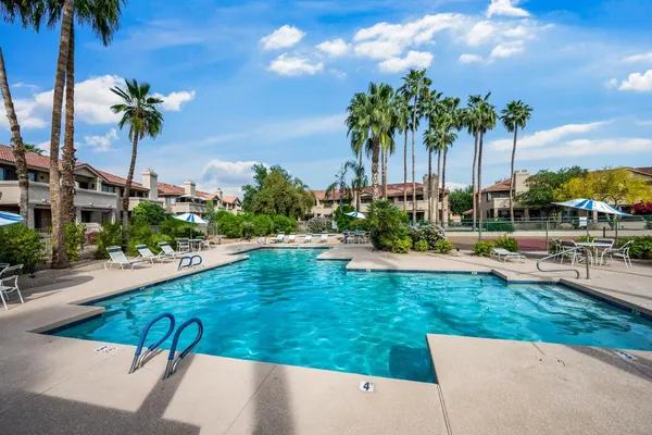 a view of swimming pool with outdoor seating and plants