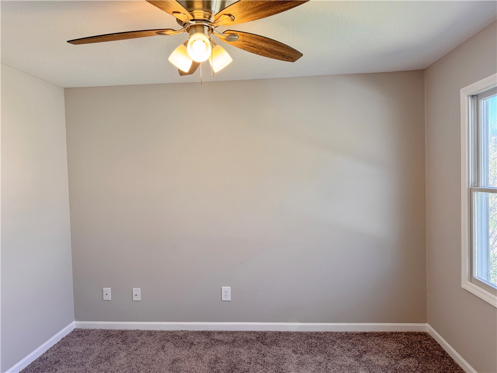 1118 Wedgewood Court Decatur, IL 62526 - Photo 20 of 22 a view of an empty room and window with chandelier fan