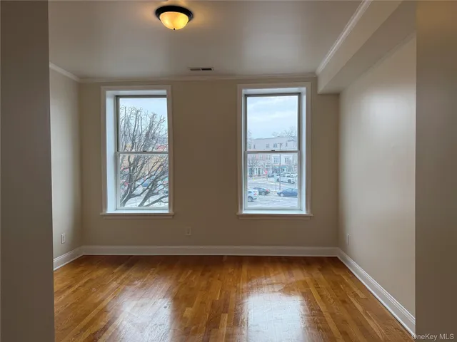a view of a livingroom with wooden floor and a window