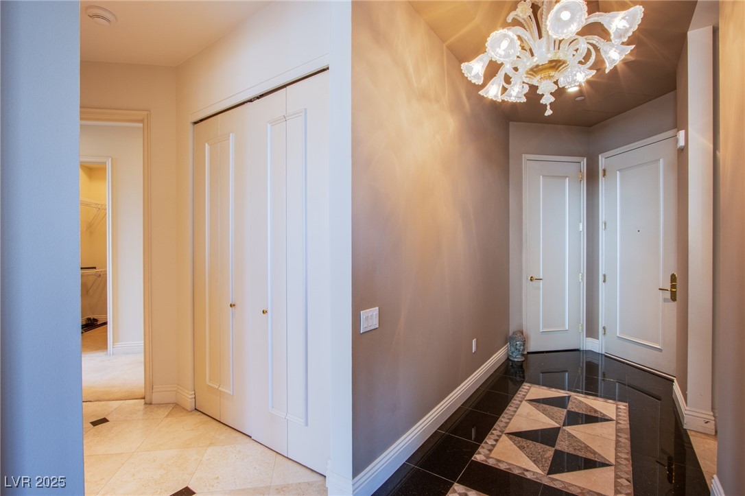 2857 Paradise Road, Unit 206 Las Vegas, NV 89109 - Photo 9 of 31 Hall featuring a chandelier and tile patterned floors