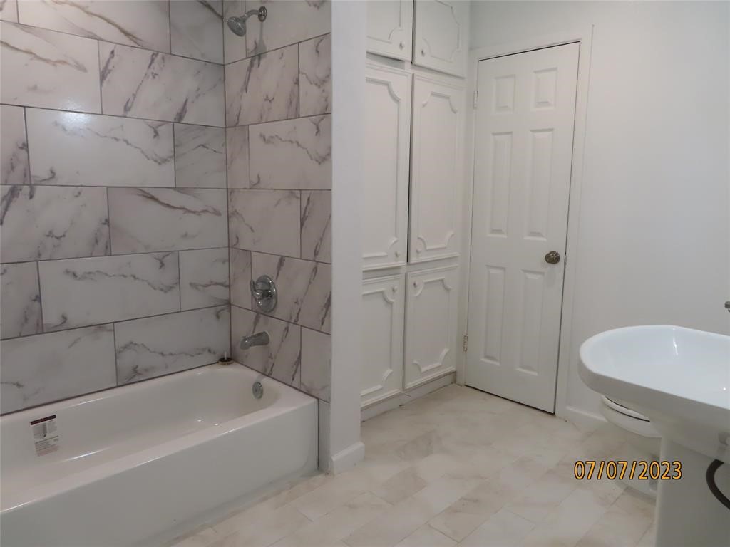 403 High Ridge Street Houston, TX 77013 - Photo 11 of 13 a bathroom with a bathtub and a shower