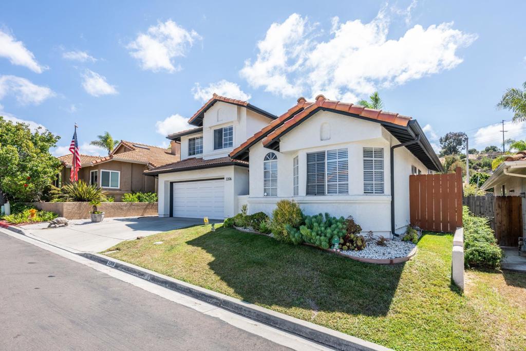 2206 Luz Way Oceanside, CA 92056 - Photo 1 of 1 a front view of a house with a yard and garage