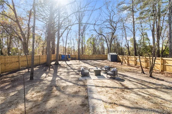 a view of a yard with snow on the road