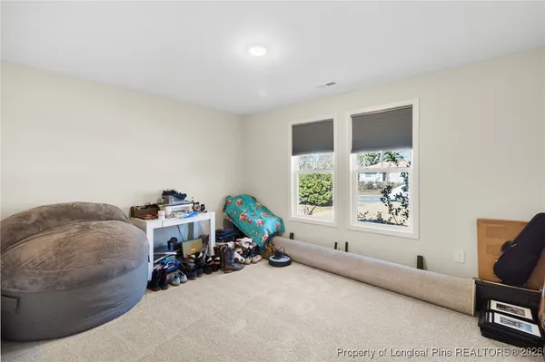 a view of a livingroom with furniture and a window