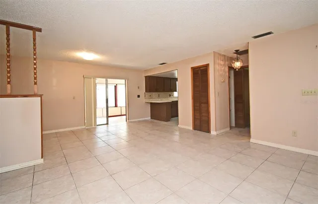 a view of a big room with closet and windows