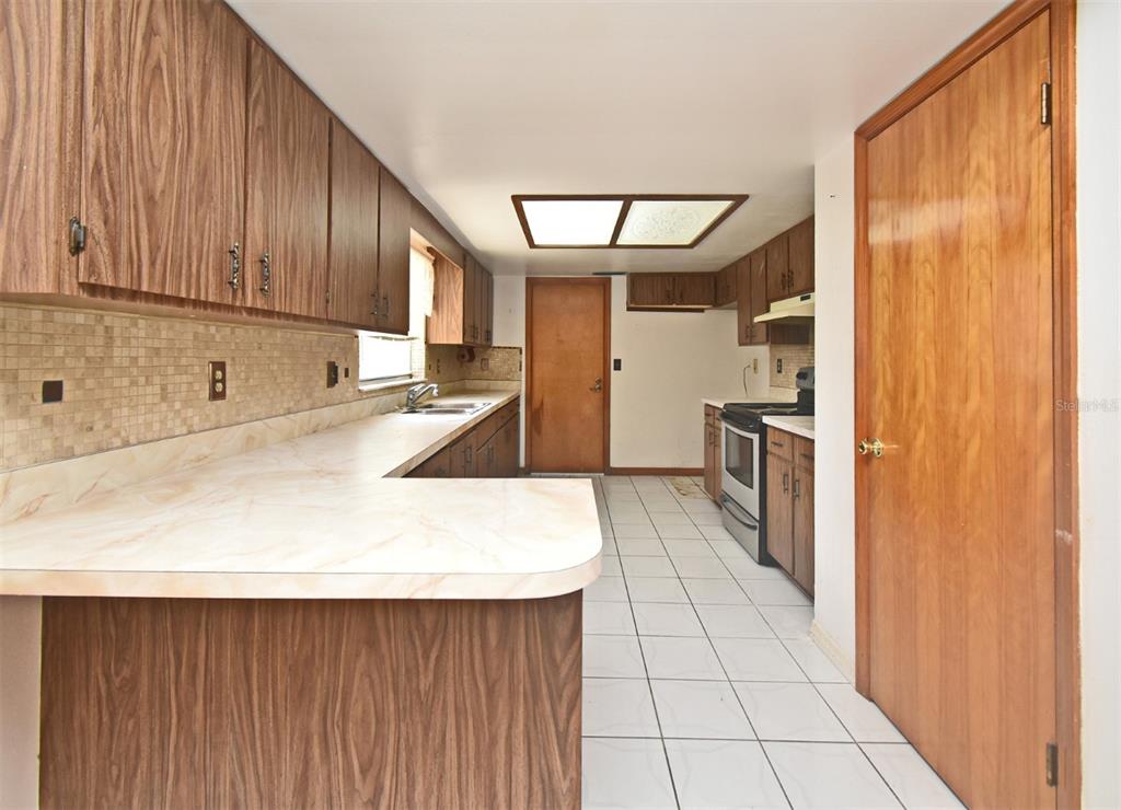 741 Arlene Drive Deltona, FL 32725 - Photo 16 of 34 a kitchen with stainless steel appliances a refrigerator and a sink