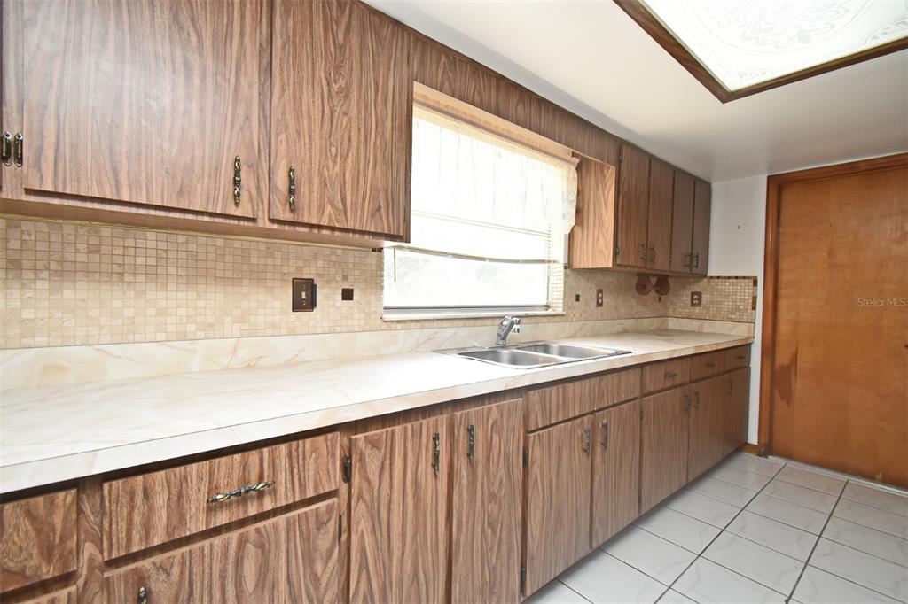 741 Arlene Drive Deltona, FL 32725 - Photo 17 of 34 a kitchen with a sink window and cabinets