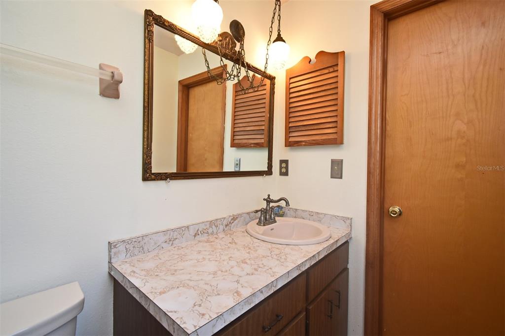 741 Arlene Drive Deltona, FL 32725 - Photo 26 of 34 a bathroom with a granite countertop sink and a mirror