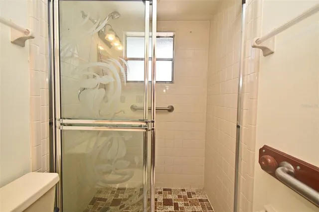 a bathroom with a glass shower door