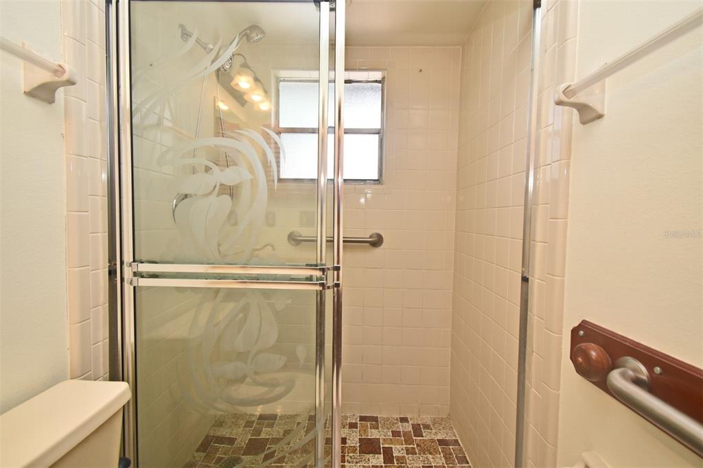 741 Arlene Drive Deltona, FL 32725 - Photo 30 of 34 a bathroom with a glass shower door
