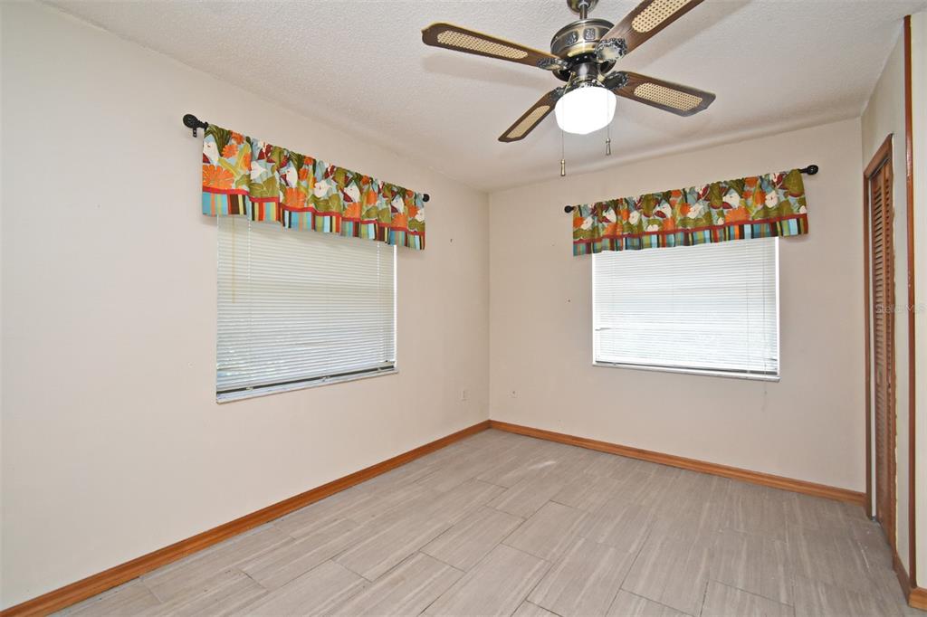 741 Arlene Drive Deltona, FL 32725 - Photo 32 of 34 an empty room with a window and a ceiling fan