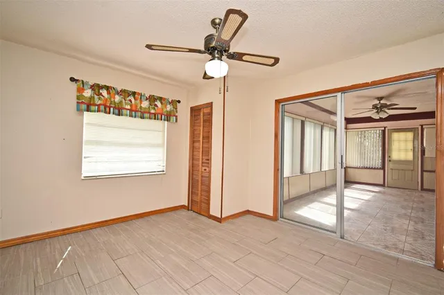 a view of a livingroom with a ceiling fan and window