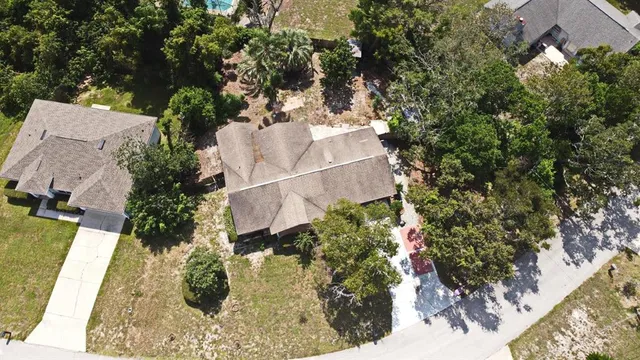 an aerial view of a house with a yard