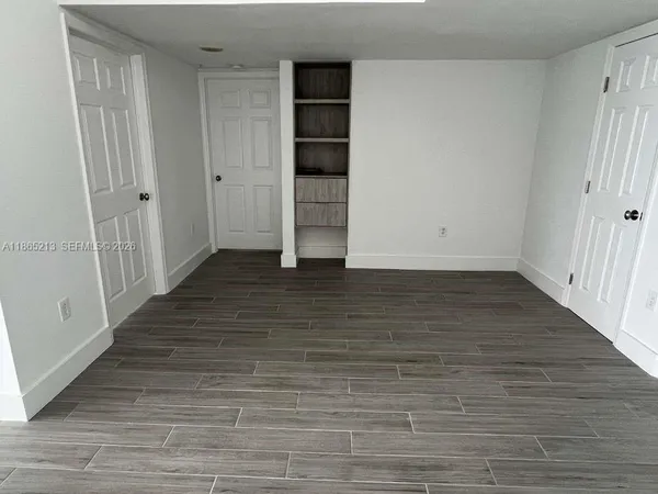 a kitchen with a sink a refrigerator and cabinets