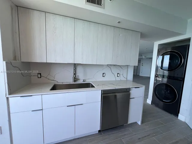 a kitchen with a sink stove and microwave