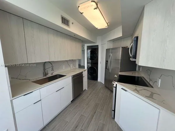 a kitchen with a refrigerator stove and microwave
