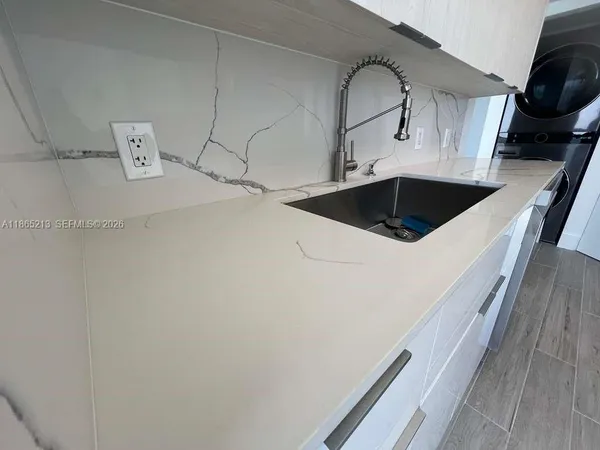 a bathroom with a sink and mirror