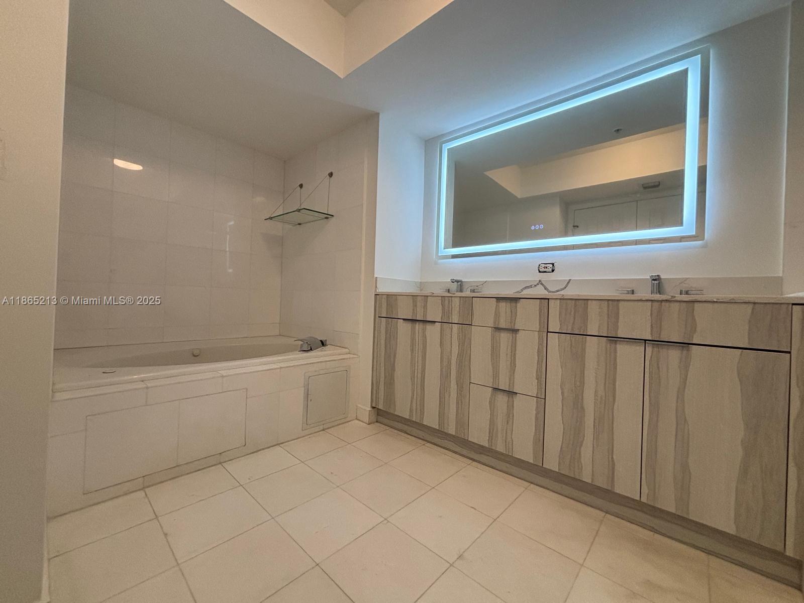 6301 Collins Avenue, Unit 3002 Miami Beach, FL 33141 - Photo 17 of 27 a bathroom with a sink a toilet and bathtub