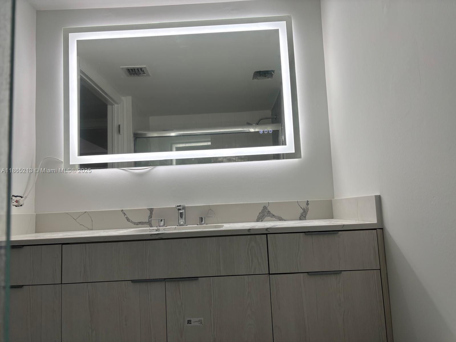 6301 Collins Avenue, Unit 3002 Miami Beach, FL 33141 - Photo 19 of 27 a close view of sink and tap