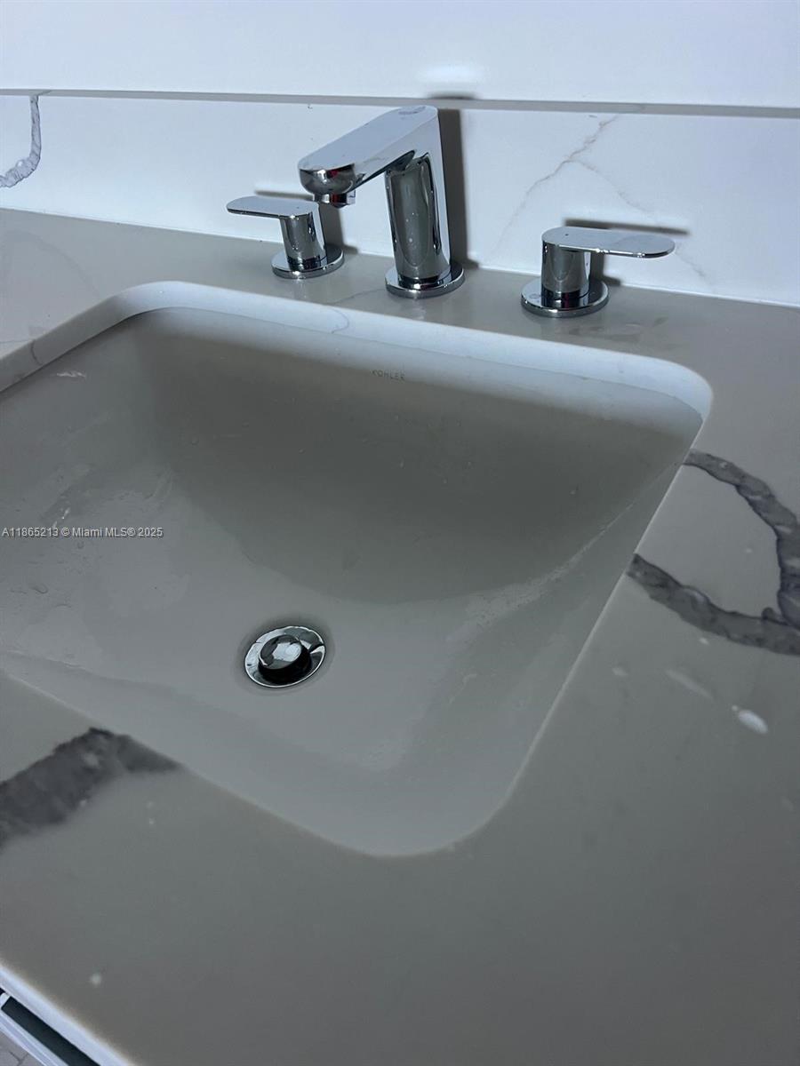6301 Collins Avenue, Unit 3002 Miami Beach, FL 33141 - Photo 21 of 27 a bathroom with a sink