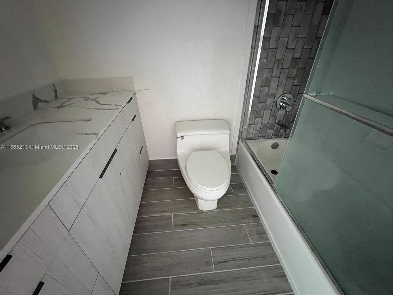 6301 Collins Avenue, Unit 3002 Miami Beach, FL 33141 - Photo 22 of 27 a bathroom with a toilet and a shower