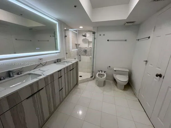 a hallway with cabinets and two wooden floors