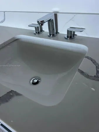 a bathroom with a granite countertop toilet sink and mirror