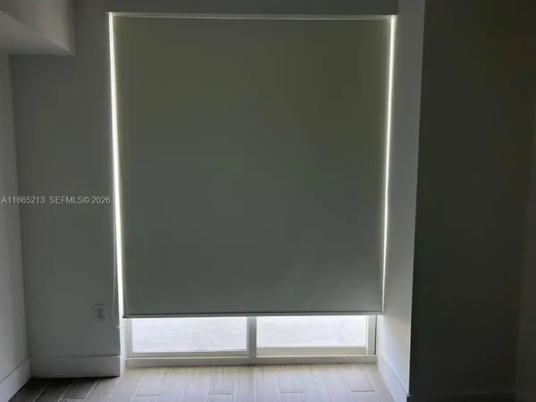 a kitchen with stainless steel appliances kitchen island granite countertop a sink and white cabinets
