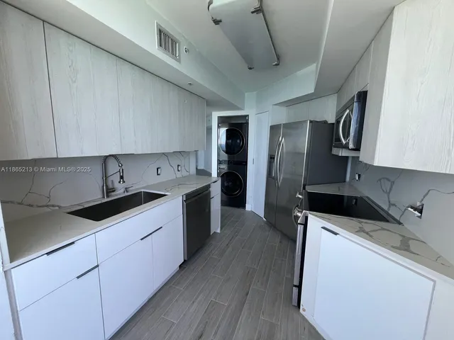 a kitchen with a sink and a refrigerator