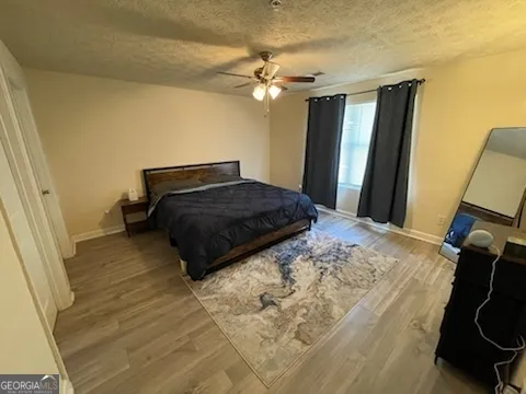 a bedroom with a bed and a mirror