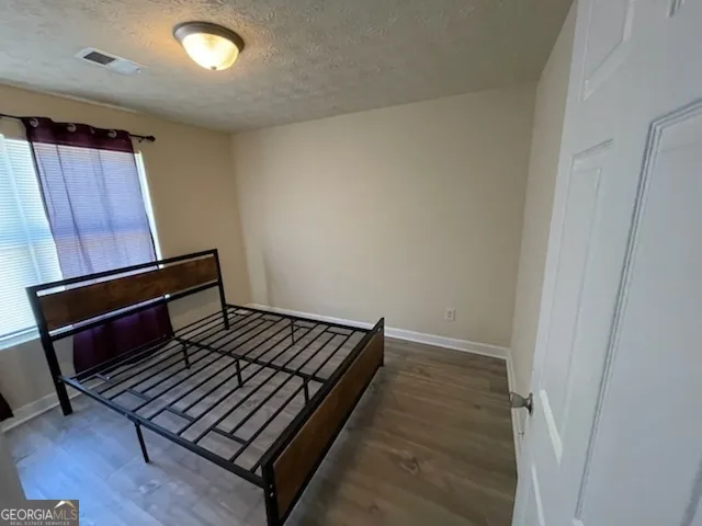 a view of an empty room and wooden floor