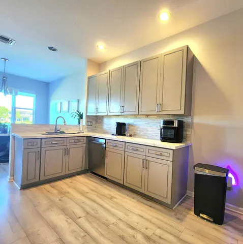 a kitchen with kitchen island granite countertop a cabinets and white appliances