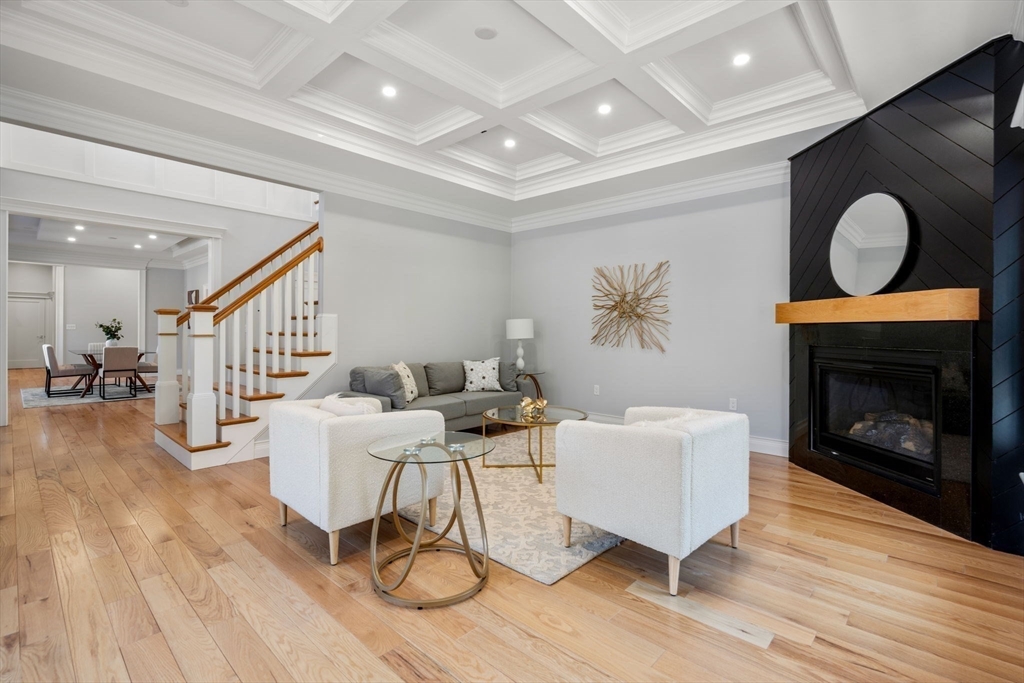 10 Hitching Post Lane Weston, MA 02493 - Photo 5 of 42 a living room with furniture a fireplace and a table